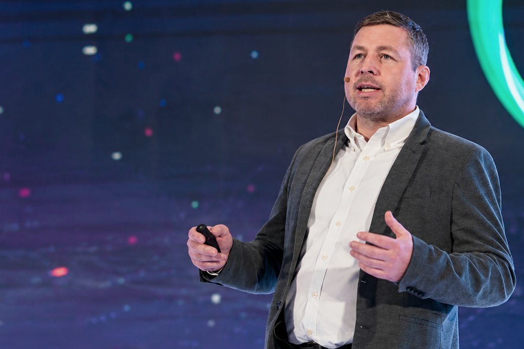 Liam Corcoran speaking on stage at World AI Show in Dubai